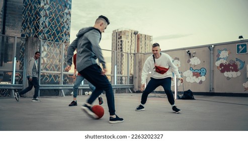 Multiethnic Diverse Friends Playing Soccer Outside on Rooftop Urban City Location. Skilful Young Man Dribbling, Passing Opponents Alone with the Ball and Scoring a Goal - Powered by Shutterstock