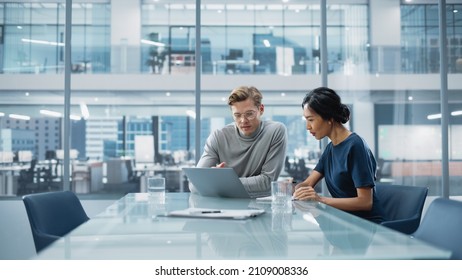 Multiethnic Diverse Office Conference Room Meeting: Team of Two Creative Entrepreneurs Talk, Discuss Growth Strategy. Stylish Young Businesspeople work on Investment and Marketing Projects. - Powered by Shutterstock