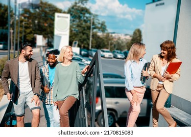 Multiethnic diverse young business people going up stairs in corporate district - Powered by Shutterstock