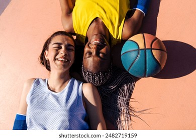 Multiethnic female basketball players training at city basketball court - Athletic women playing basketball outdoors, concepts about sport, lifestyle and gender equality - Powered by Shutterstock