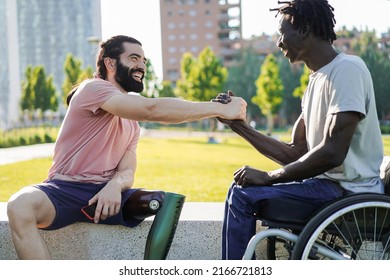 Multiethnic friends with disability greeting each other at park city - Focus on prosthetic leg - Powered by Shutterstock