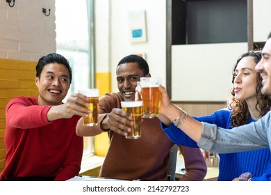 Multiethnic Friends Drinking Beer At Brewery Bar Restaurant On Weekend - Friendship Concept With Young People Having Fun Together Toasting Brew Pint On Happy Hour At Pub - Focus On Middle Eastern Man