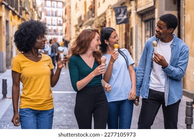 Multi-ethnic friends eating an ice cream cone, summer fun, walking down the street - Shutterstock ID 2277105973