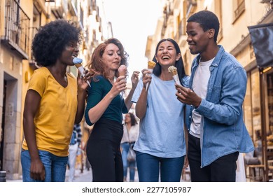 Multi-ethnic friends eating an ice cream cone, summer fun, walking down the street