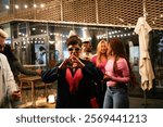 Multiethnic friends enjoying a night out, celebrating and having fun together at a trendy venue