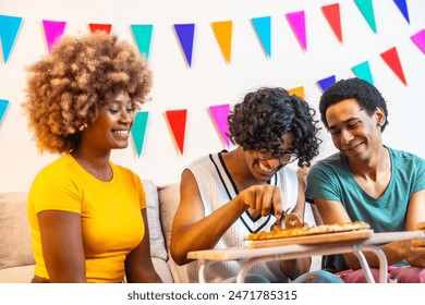 Multi-ethnic friends sharing homemade pizza during a party at home - Powered by Shutterstock