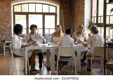 Multiethnic Group Of Art School Students Of Young And Mature Ages Enjoying Artistic Hobby Together, Studying Drawing On Art School Studio Class, Painting At Table, Chatting, Laughing