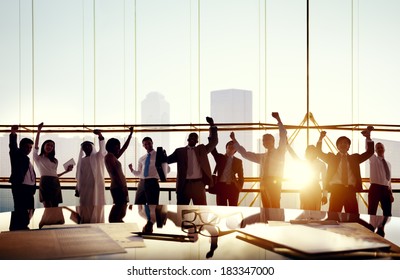 Multi-Ethnic Group Of Business People Celebrating In Board Room