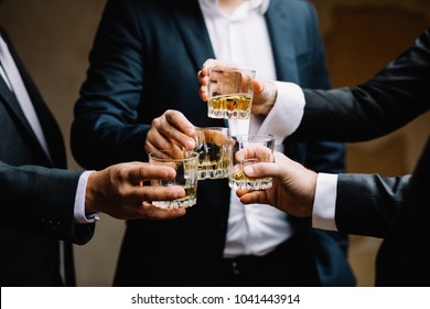 Multiethnic group of businessmen spending time together drinking - Powered by Shutterstock