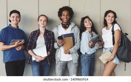 Multiethnic group of cheerful young students standing together outdoors, panorama - Powered by Shutterstock