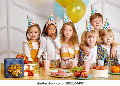 multi-ethnic group of children friends celebrating birthday, little kids have birthday party, congratulating friend, have fun and entertainment - Powered by Shutterstock