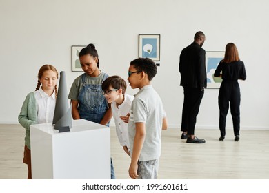 Multi-ethnic Group Of Children Looking At Sculptures In Modern Art Gallery, Copy Space