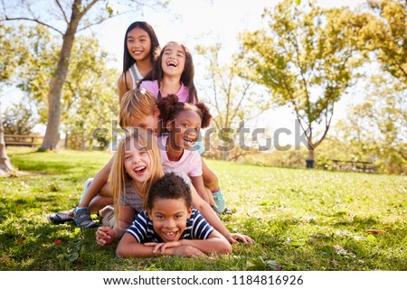 Multi-ethnic group of children lying in a pile in a park Foto stock © 
