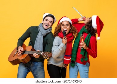 Multiethnic group of close friends having party singing and celebrating Christmas in yellow studio isolated background - Powered by Shutterstock