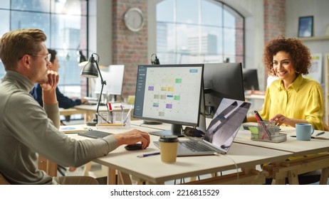 Multiethnic Group of Creative Colleagues Working on Computers in a Modern Bright Office. Male Administrator Preparing a Presentation on Time Management. Biracial Businesswoman Smiling. - Powered by Shutterstock