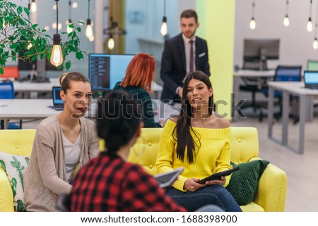 Multiethnic group of employees working in a google environment company. Group of colleagues working on a project in modern offices