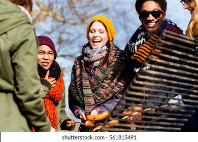 Multi-ethnic group of five young people having fun at barbecue