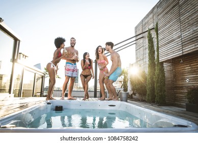 Multi-ethnic group of friends having party on  rooftop - Happy people bonding and having fun - Shutterstock ID 1084758242