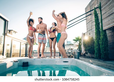 Multi-ethnic group of friends having party on  rooftop - Happy people bonding and having fun - Shutterstock ID 1084758245