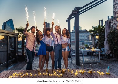 Multi-ethnic group of friends having party on  rooftop - Happy people bonding and having fun