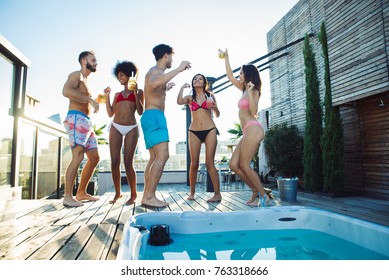 Multi-ethnic group of friends having party on  rooftop - Happy people bonding and having fun - Shutterstock ID 763318666