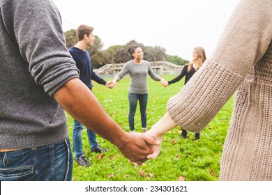 Multiethnic Group Of Friends Holding Hands In A Circle