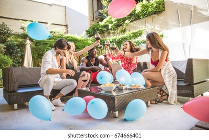 Multiethnic Group Of Friends Making Party In A Lounge Bar - Cheerful Young Adults Having Fun And Celebrating In A Backyard Garden With Swimming Pool