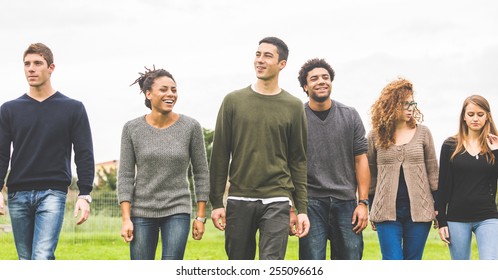 Multiethnic Group Of Friends At Park Walking And Enjoying Time All Together. Mixed Race Group With Caucasian, Black And Asian People. Friendship, Lifestyle, Immigration Concepts.