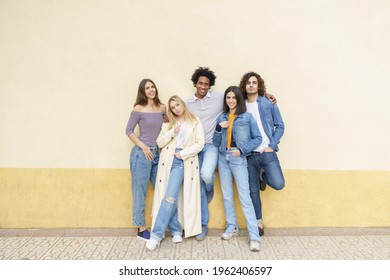 Multi-ethnic group of friends posing while having fun and laughing together