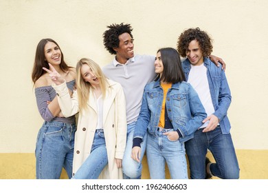 Multi-ethnic group of friends posing while having fun and laughing together