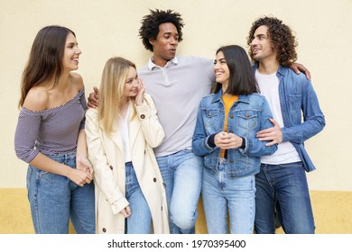 Multi-ethnic group of friends posing while having fun and laughing together
