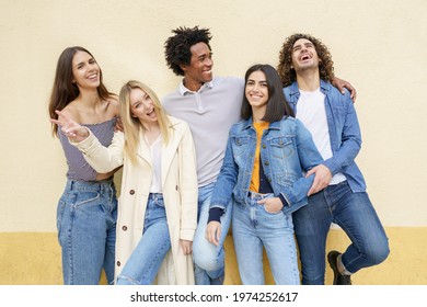 Multi-ethnic group of friends posing while having fun and laughing together