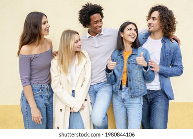 Multi-ethnic group of friends posing while having fun and laughing together
