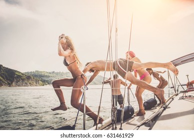 Multiethnic group of friends sailing on a boat - Summer holidays, young adults having fun