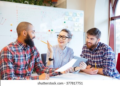 Multiethnic group of happy business people working together in office - Powered by Shutterstock