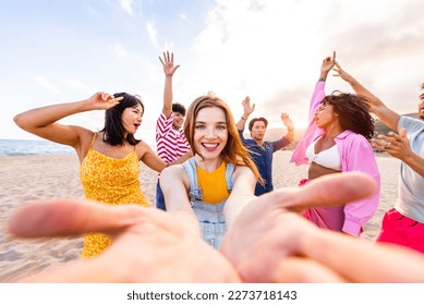 Multiethnic group of happy friends bonding and having fun at the beach on summer vacation - Multiracial real authentic people spending time together at the sea, concepts about youth and summertime - Powered by Shutterstock