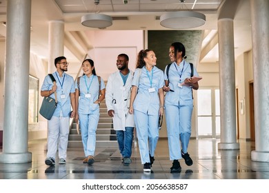 Multi-ethnic group of happy medical and nursing students talking through a hallway and talking.  - Powered by Shutterstock