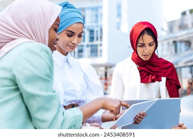 Multiethnic group of muslim girls wearing casual clothes and traditional hijab bonding and having fun outdoors - 3 arabic young girls - Powered by Shutterstock