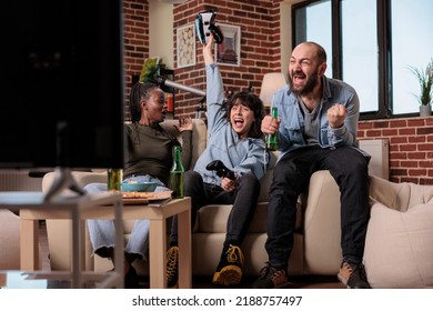 Multiethnic Group Of People Celebrating Video Games Victory, Winning Game With Augmented Reality Goggles On Tv Console. Friends Using Vr Glasses To Win Competition At House Party, Leisure Activity.