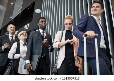 Multiethnic group of people standing in the queue at the airport and registering before flight