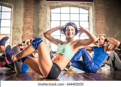 Multi-ethnic Group Of People Training In A Gym - Personal  Trainer And Sportive Persons  In A Fitness Class