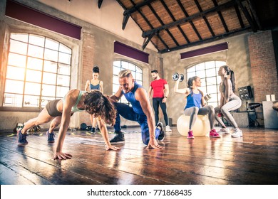 Multi-ethnic Group Of People Training In A Gym - Personal  Trainer And Sportive Persons  In A Fitness Class