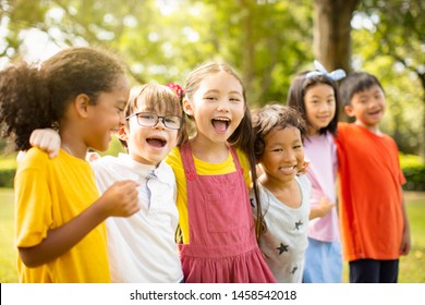 Multi-ethnic Group Of School Children Laughing And Embracing