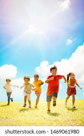 Multi-ethnic Group Of School Children Laughing And Running