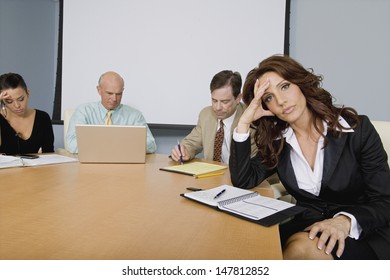 Multiethnic Group Of Serious Businesspeople At A Meeting