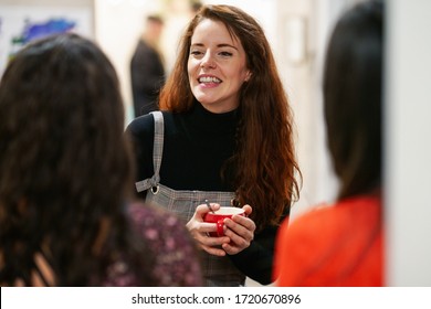 Multiethnic Group Of Three Happy Female Friends Drinking Coffee In A Cafe Bar.