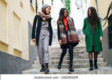 Multiethnic Group Of Three Happy Woman Walking In Urban Background