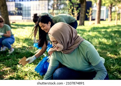 Multiethnic group of volunteers with garbage bags cleaning city park. - Powered by Shutterstock