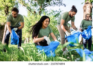 Multiethnic group of volunteers with garbage bags cleaning city park. - Powered by Shutterstock