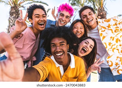 Multiethnic group of young happy friends hanging out in the city taking selfie - Multiracial group of students meeting and having fun outdoors, concepts about youth, teenage, diversity and lifestyle - Powered by Shutterstock